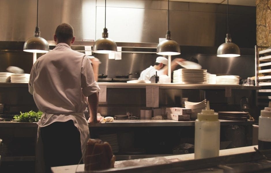 Professional chefs working in a busy commercial kitchen environment